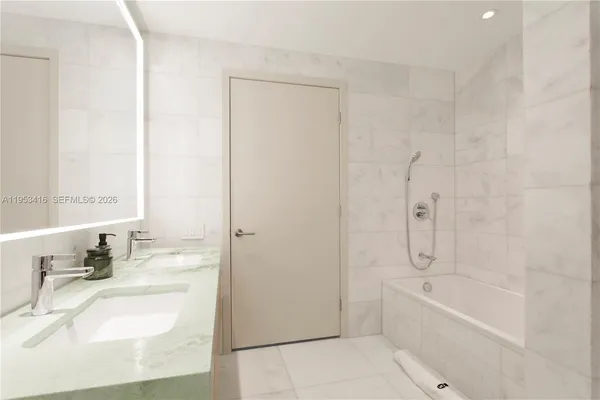 a bathroom with a bathtub and a sink