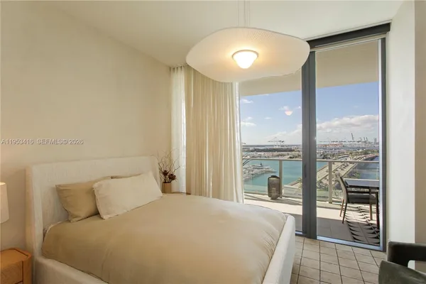 a bedroom with a large bed and a large window