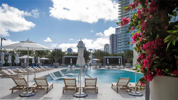 a swimming pool with outdoor seating and yard