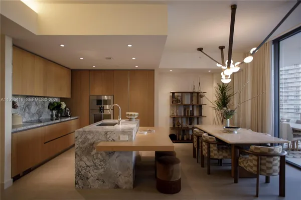 a kitchen with counter space dining table and chairs