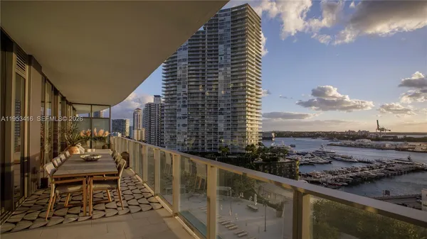 a balcony with outdoor seating and city view
