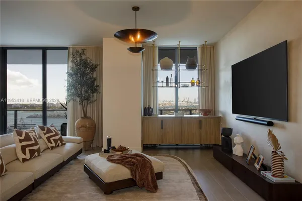 a living room with furniture and a flat screen tv