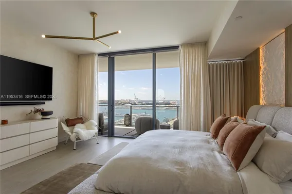 a bedroom with a bed and large window