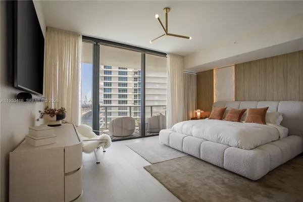 a bedroom with a bed and large window