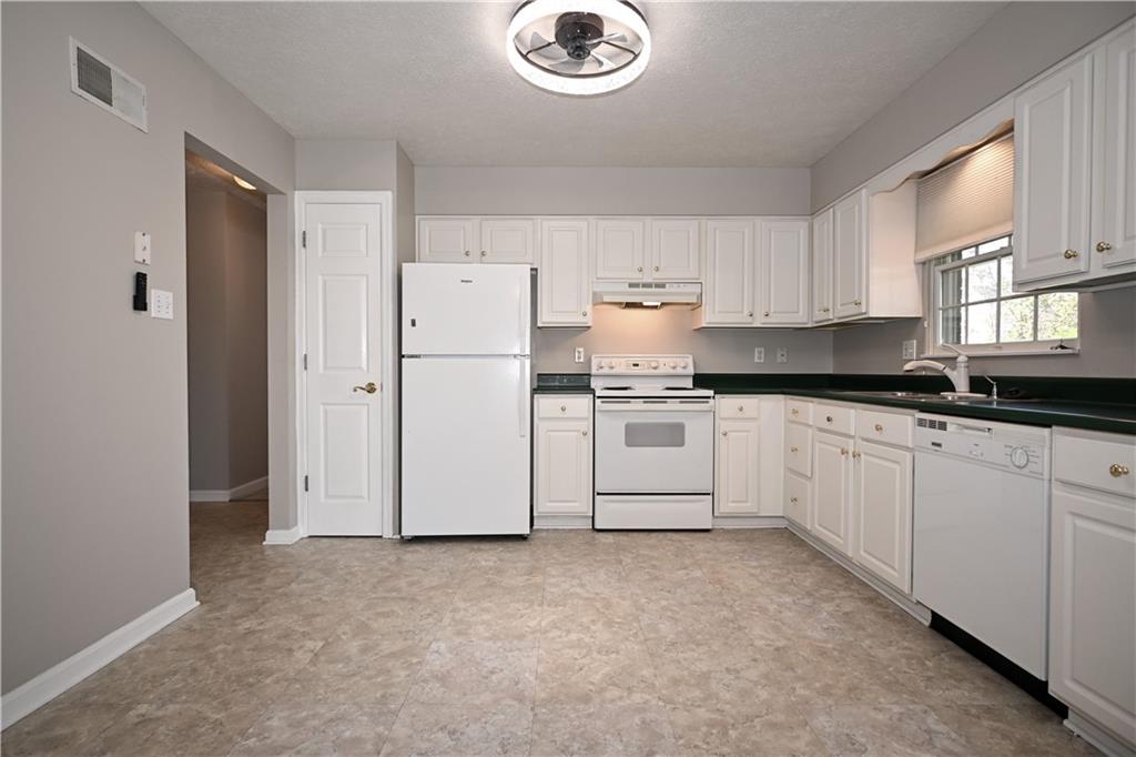 124 Valleycrest Drive Cecil, PA 15321 - Photo 12 of 38 a kitchen with granite countertop white cabinets and white appliances