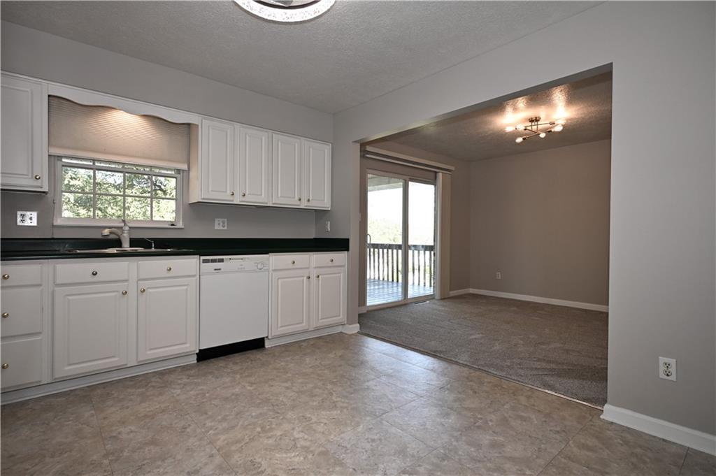 124 Valleycrest Drive Cecil, PA 15321 - Photo 13 of 38 a kitchen with granite countertop white cabinets and window