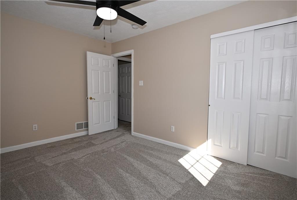 124 Valleycrest Drive Cecil, PA 15321 - Photo 19 of 38 an empty room with a ceiling fan and window