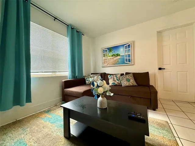 a living room with furniture and a window