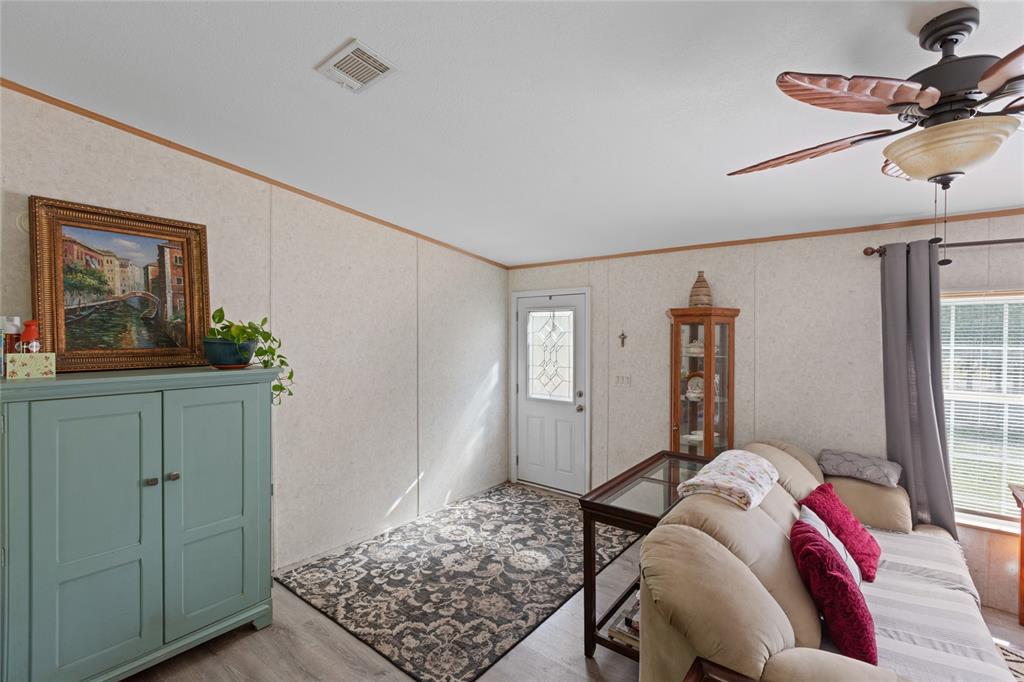 5670 Acadia Street Keystone Heights, FL 32656 - Photo 32 of 65 a bedroom with a bed and wooden floor