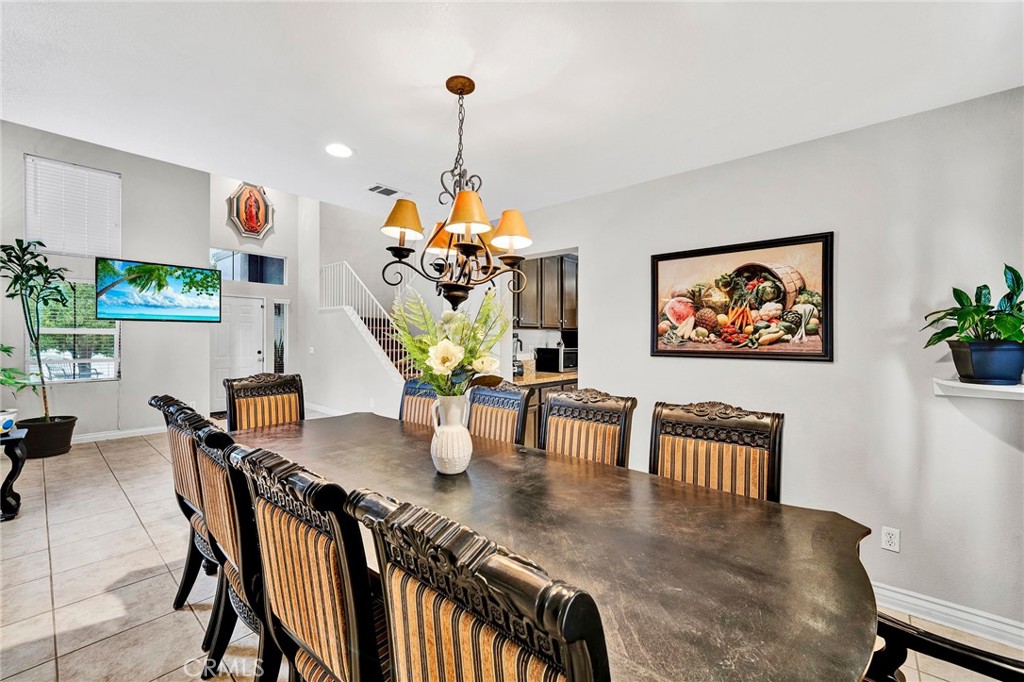 31755 Ridgeview Drive Lake Elsinore, CA 92532 - Photo 12 of 36 a view of a dining room and livingroom with furniture wooden floor a chandelier
