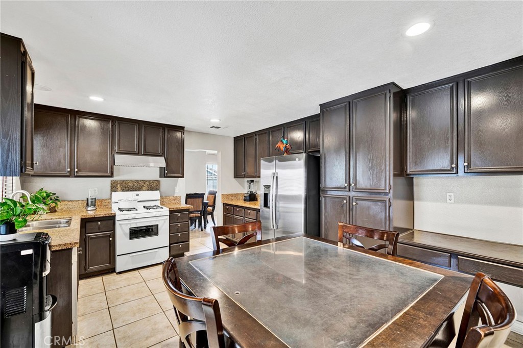 31755 Ridgeview Drive Lake Elsinore, CA 92532 - Photo 17 of 36 a kitchen with kitchen island a large counter appliances and cabinets