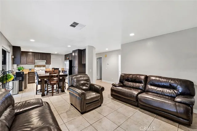 a living room with furniture kitchen view and a dining table