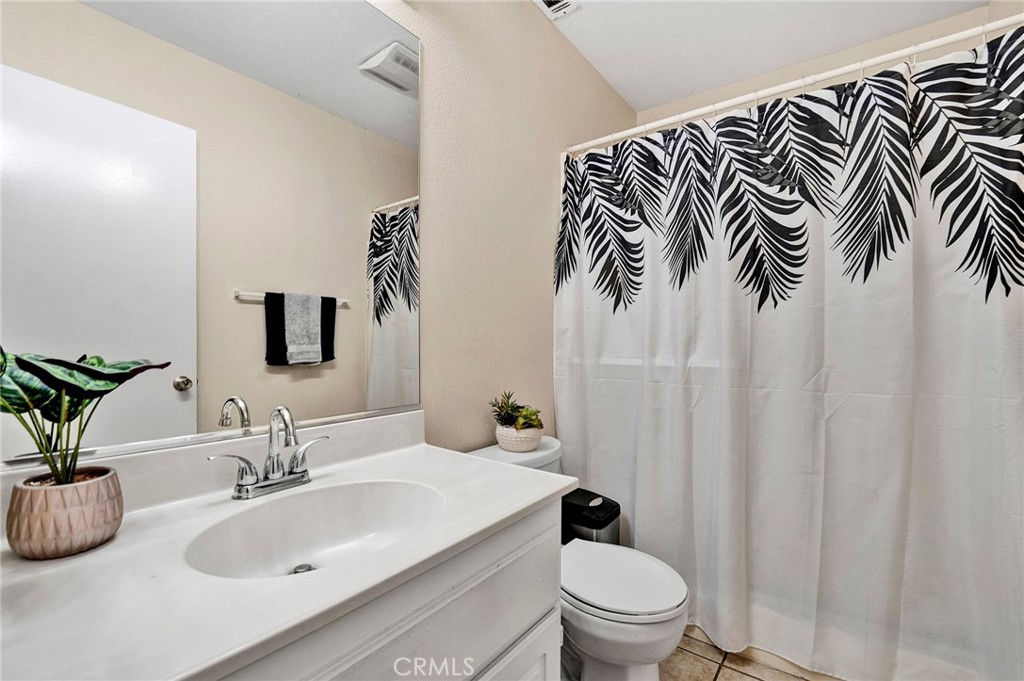 31755 Ridgeview Drive Lake Elsinore, CA 92532 - Photo 25 of 36 a bathroom with a sink a toilet and a mirror