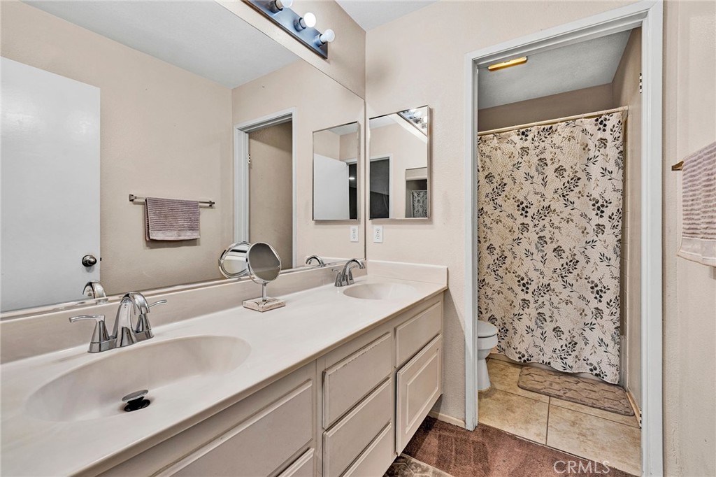 31755 Ridgeview Drive Lake Elsinore, CA 92532 - Photo 29 of 36 a bathroom with a sink double vanity and shower