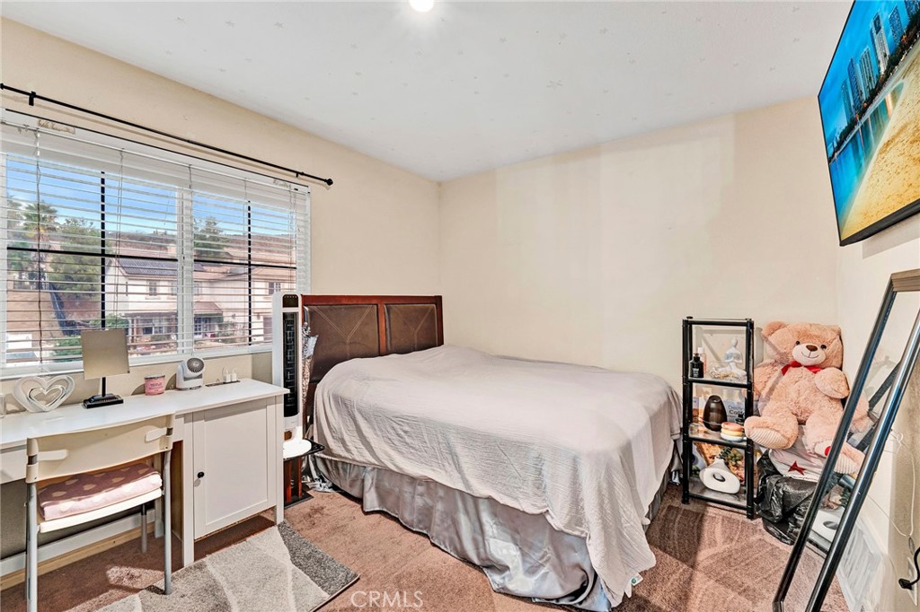 31755 Ridgeview Drive Lake Elsinore, CA 92532 - Photo 31 of 36 a bedroom with a bed and a large window