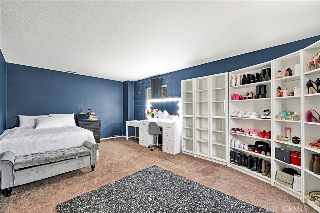 31755 Ridgeview Drive Lake Elsinore, CA 92532 - Photo 32 of 36 a bedroom with a bed and a walk in closet