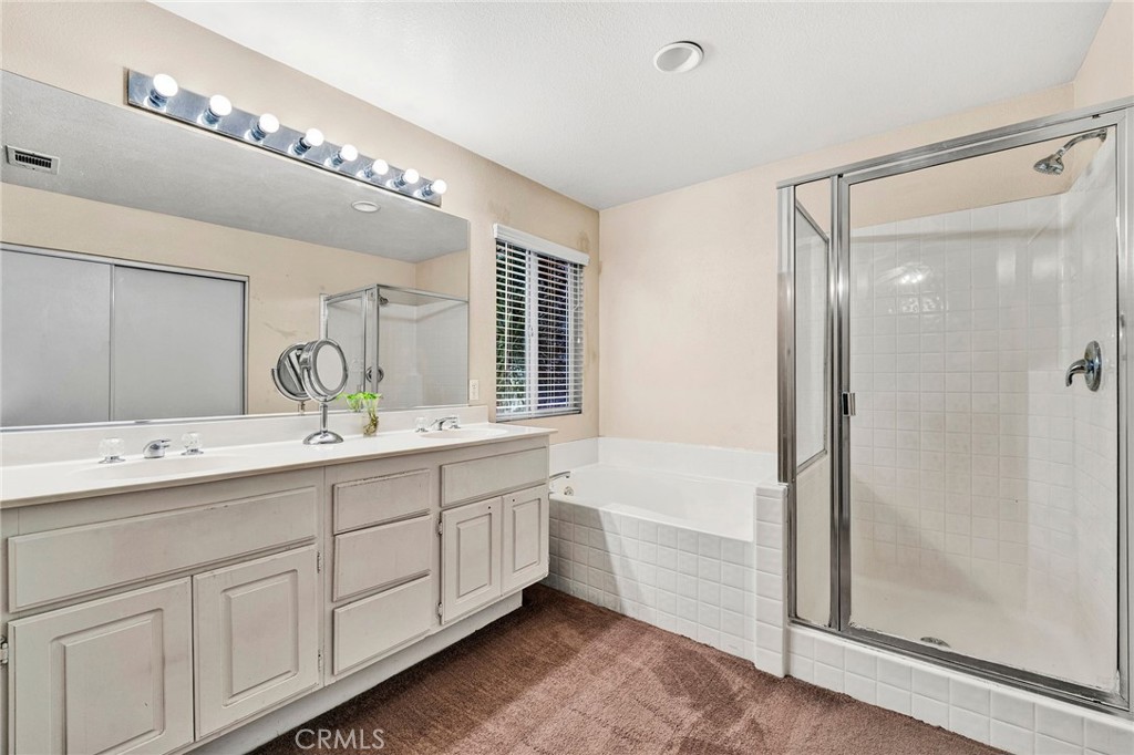 31755 Ridgeview Drive Lake Elsinore, CA 92532 - Photo 33 of 36 a spacious bathroom with a double vanity sink a mirror and a shower