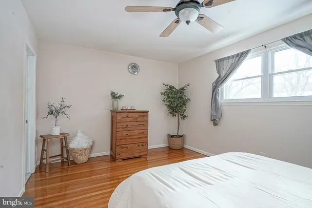 a bedroom with a bed and a potted plant