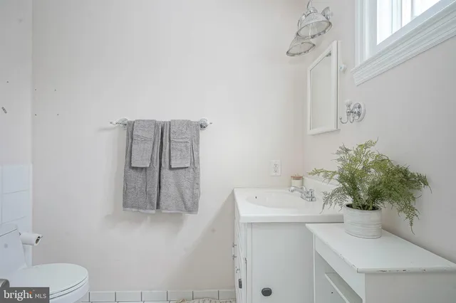 a bathroom with a sink a toilet and mirror