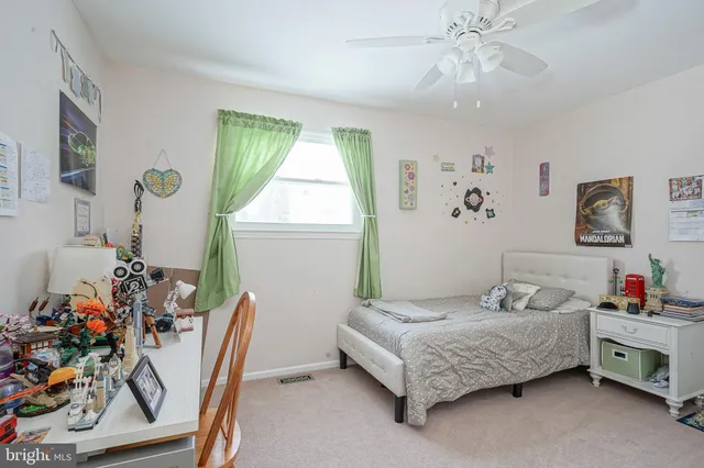 a bedroom with a bed dresser and a window