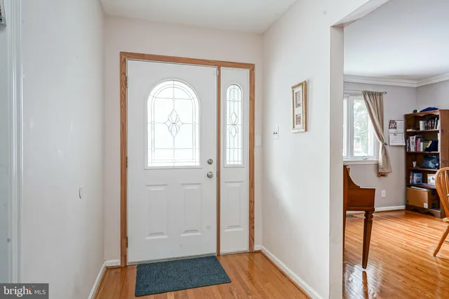 a view of a room with wooden floor and furniture