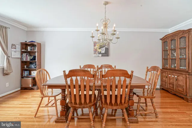 a view of a dining room with furniture wooden floor and chandelier