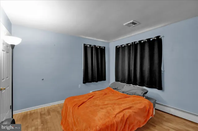 a bed sitting in a bedroom next to a window