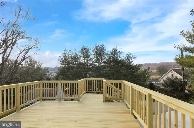 a balcony with wooden floor and fence