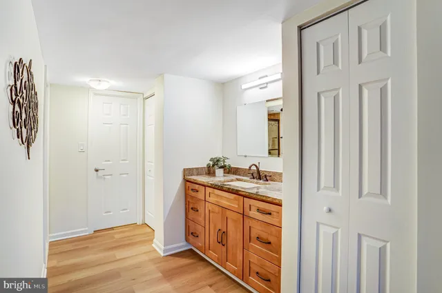 a bathroom with a sink a mirror and a shower