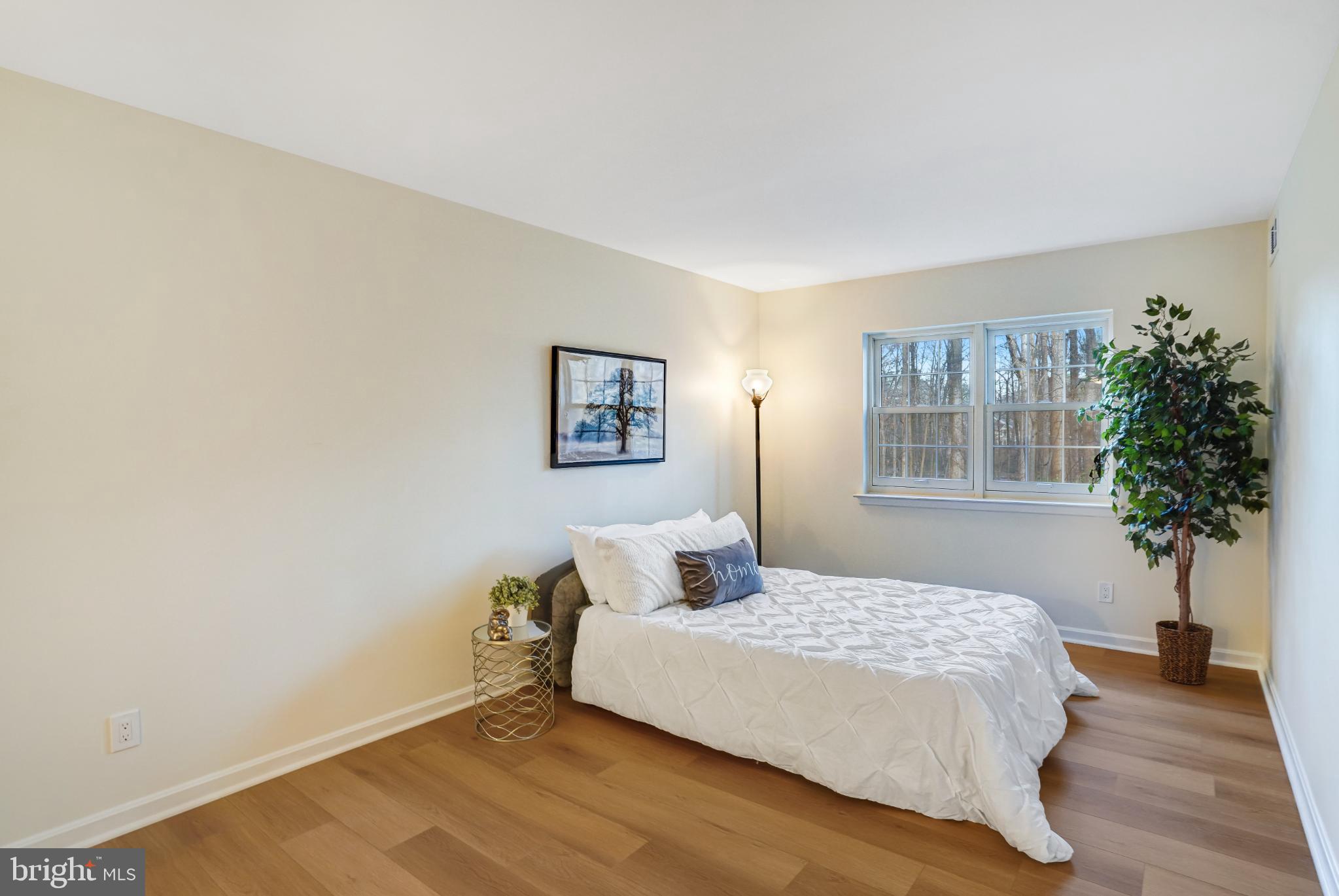 5825 Cove Landing Road, Unit 101 Burke, VA 22015 - Photo 18 of 30 Serene bedroom with natural light and greenery.
