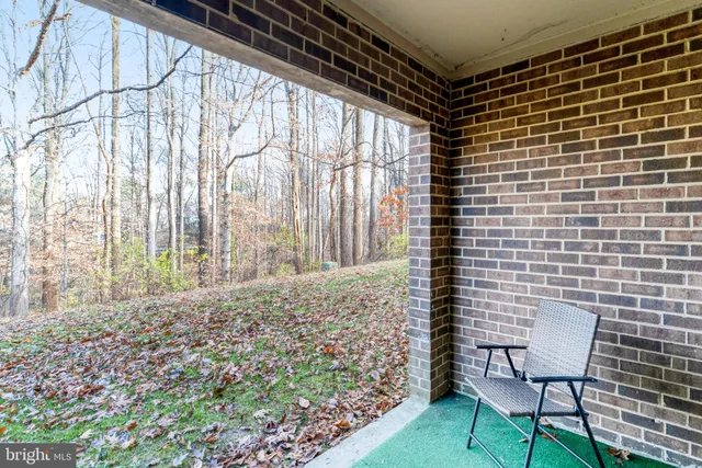 a brick building with a bench and a chair