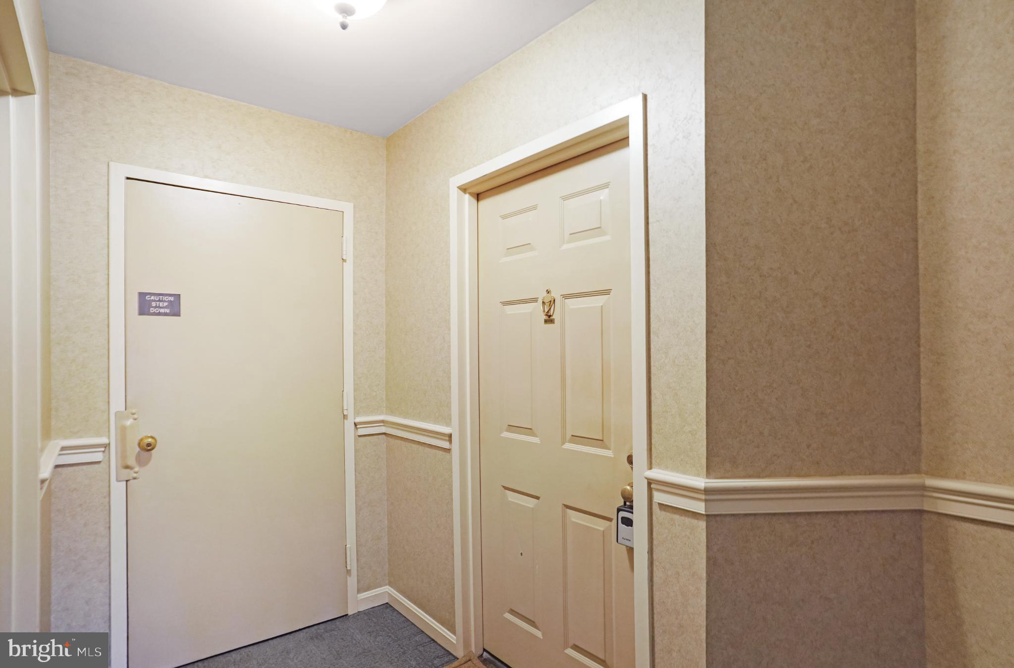 5825 Cove Landing Road, Unit 101 Burke, VA 22015 - Photo 3 of 30 Inviting hallway with classic decor.