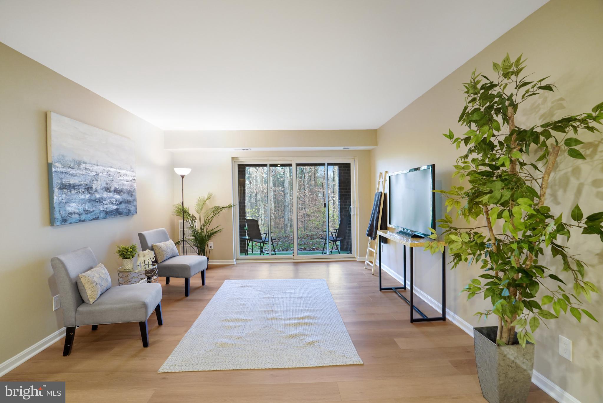 5825 Cove Landing Road, Unit 101 Burke, VA 22015 - Photo 6 of 30 Living area opens to the patio and beautiful vista