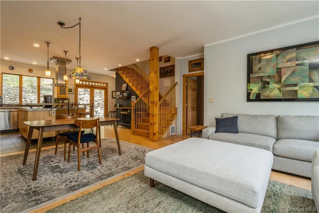 a living room with furniture a wooden floor and next to a window
