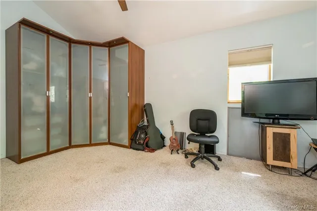 a view of a workspace with furniture and a flat screen tv