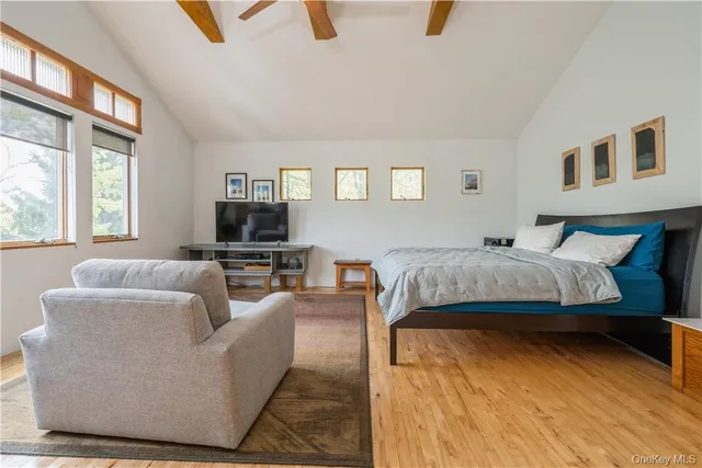 a bedroom with a bed a couch and a window