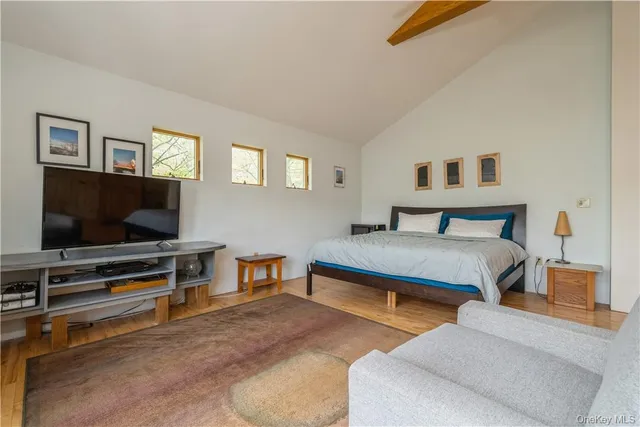 a bedroom with a bed and a flat screen tv