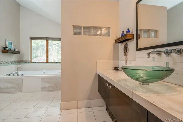 a view of a kitchen with kitchen island a sink stainless steel appliances and a counter top space