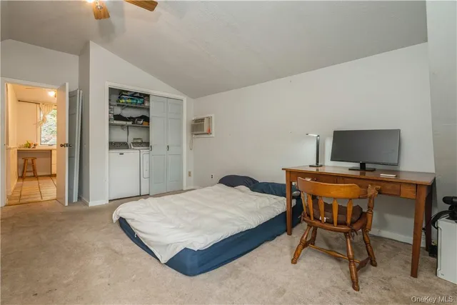 a bedroom with a bed and table chair