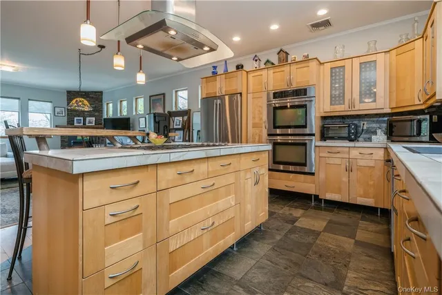 a kitchen with stainless steel appliances granite countertop a sink a stove and cabinets