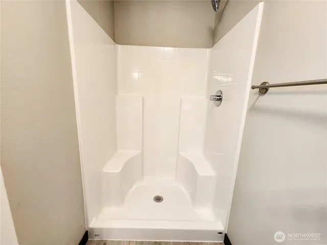 a bathroom with a glass shower door
