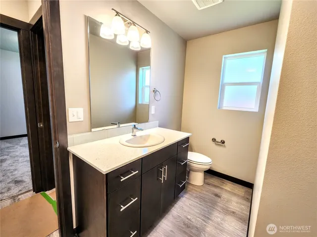 a bathroom with a toilet a sink and a mirror