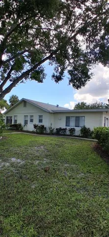 a front view of a house with a garden and deck