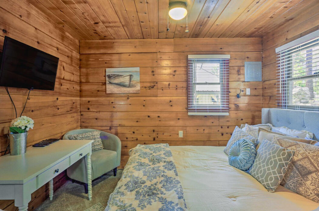 42036 Tollhouse Road Shaver Lake, CA 93664 - Photo 15 of 30 a bedroom with a bed a flat screen tv and windows