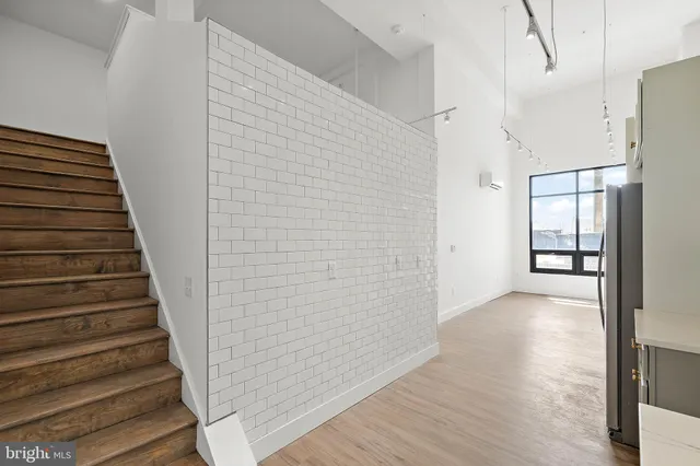 a view of an entryway with wooden floor