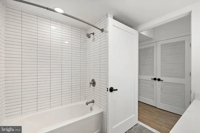 a bathroom with a bathtub and shower