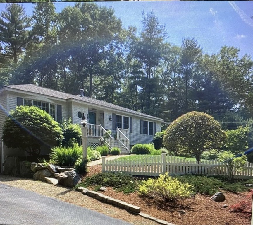 a front view of a house with a garden