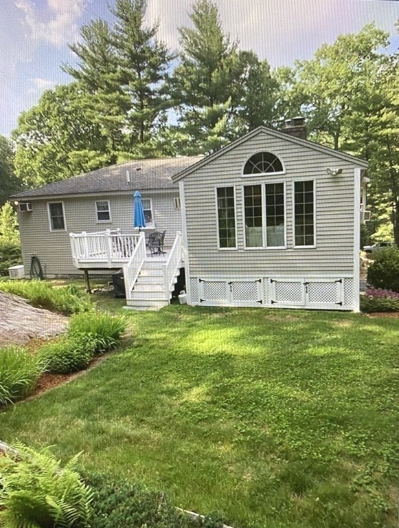 32 Freeman Road Chelmsford, MA 01824 - Photo 33 of 36 a front view of house with yard and trees in the background