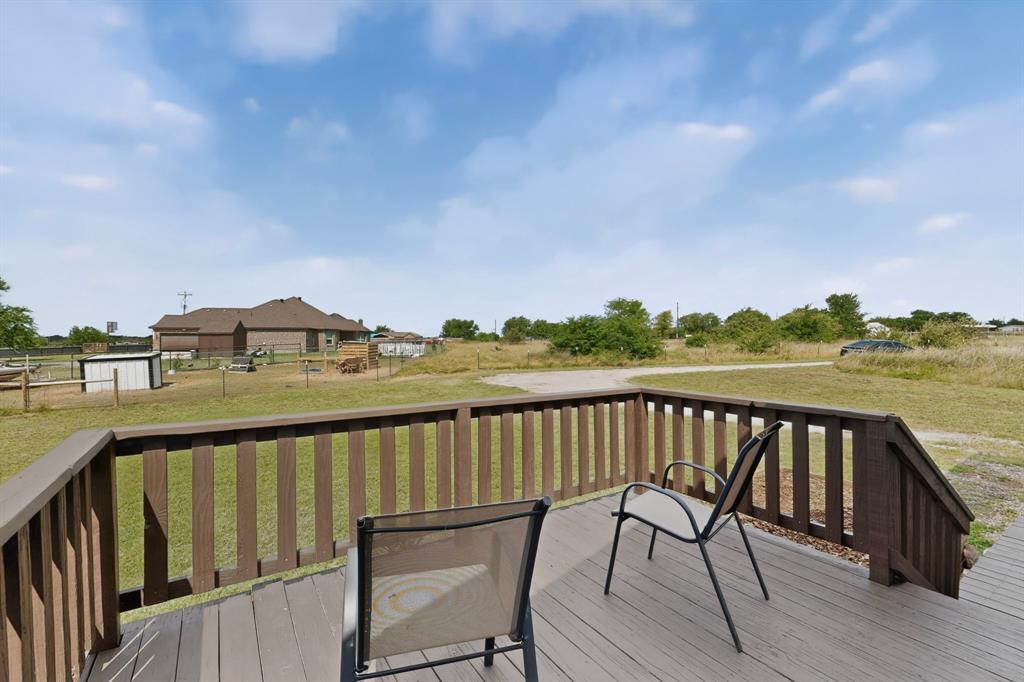 115 Vinall Circle Decatur, TX 76234 - Photo 20 of 23 a view of a balcony with wooden chairs and floor to ceiling window