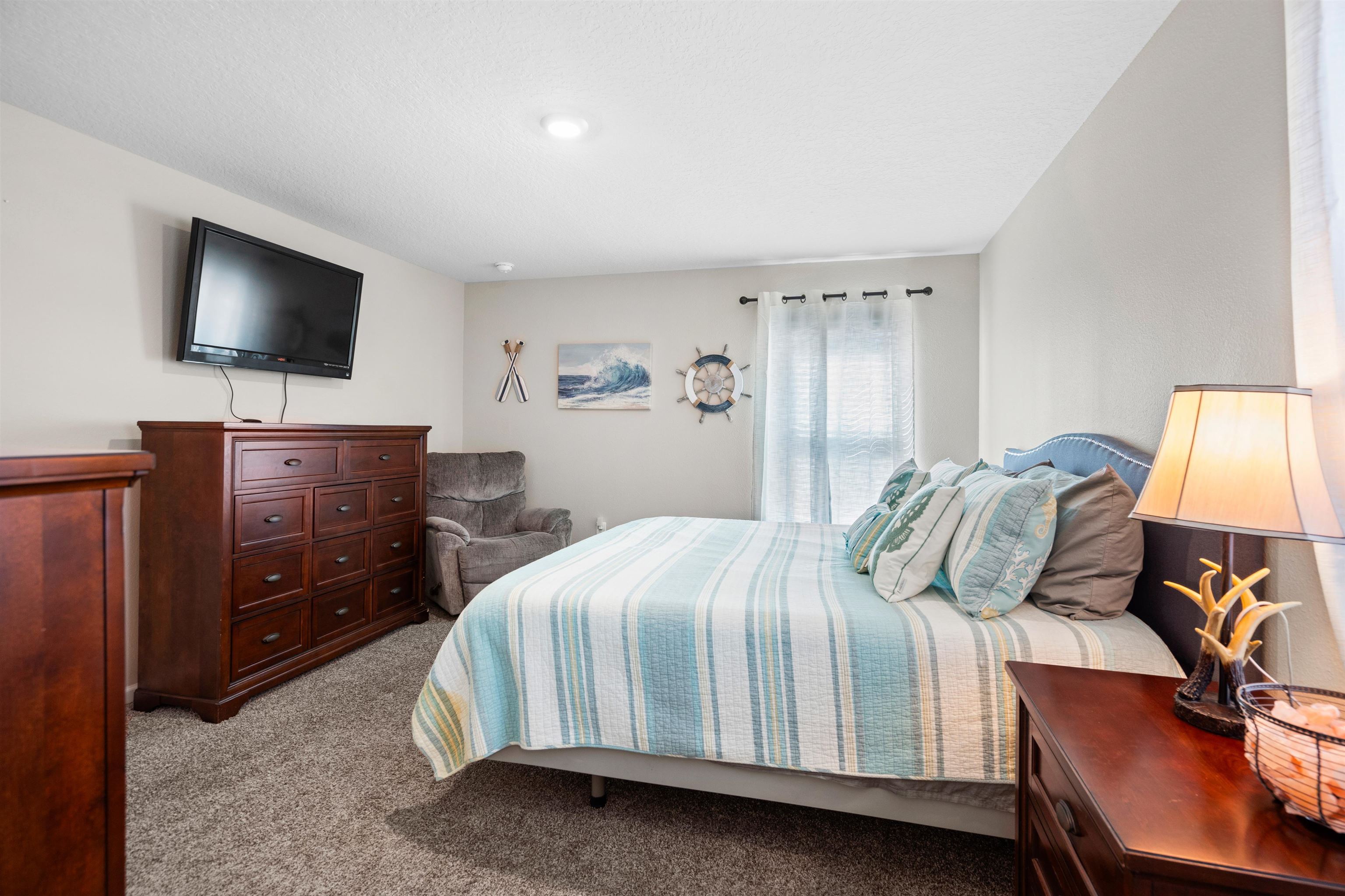 408 Falcon Ridge Road St. Augustine, FL 32084 - Photo 16 of 26 a bedroom with a bed and a flat tv screen on dresser